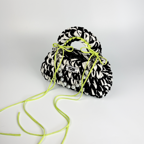 Handmade crochet handbag in black and white with a bag charm by Studio YUK