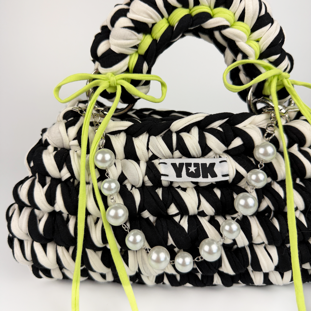 Handmade crochet handbag in black and white with a bag charm by Studio YUK