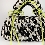 Handmade crochet handbag in black and white with a bag charm by Studio YUK