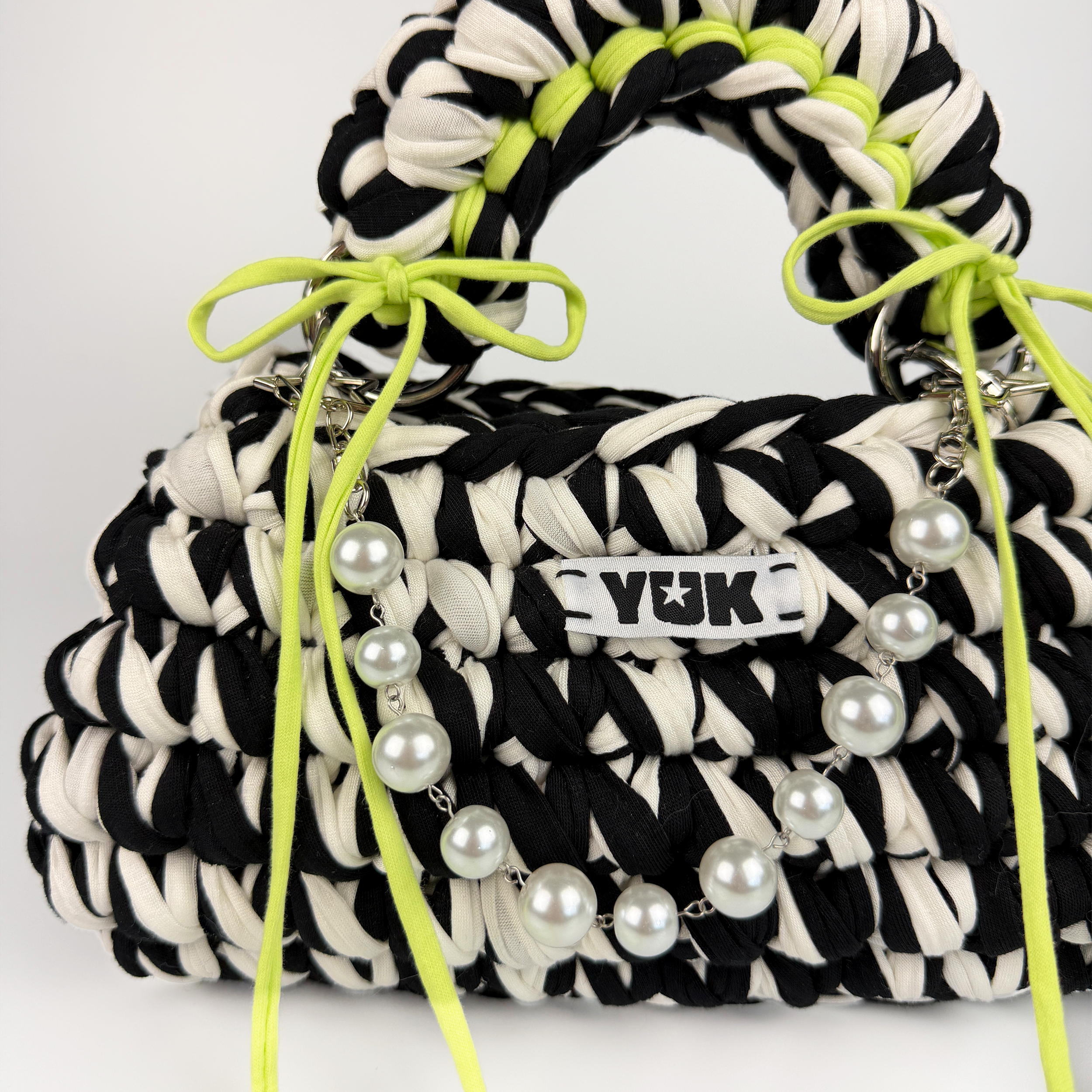 Handmade crochet handbag in black and white with a bag charm by Studio YUK