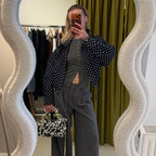 Lifestyle image featuring the black and white Studio YUK crochet handbag