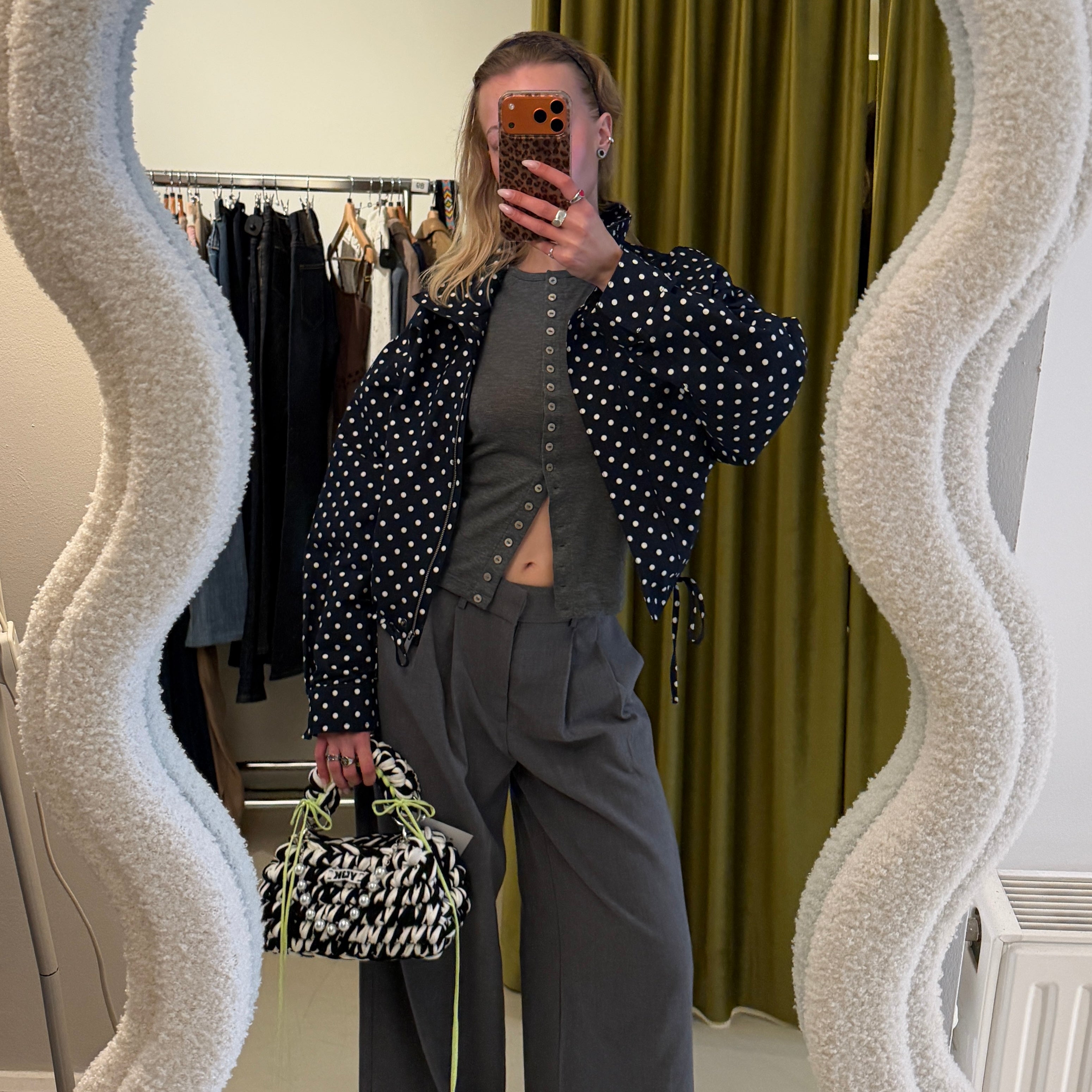 Lifestyle image featuring the black and white Studio YUK crochet handbag