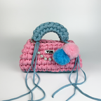 Handmade crochet handbag in pink and blue with a bag charm by Studio YUK