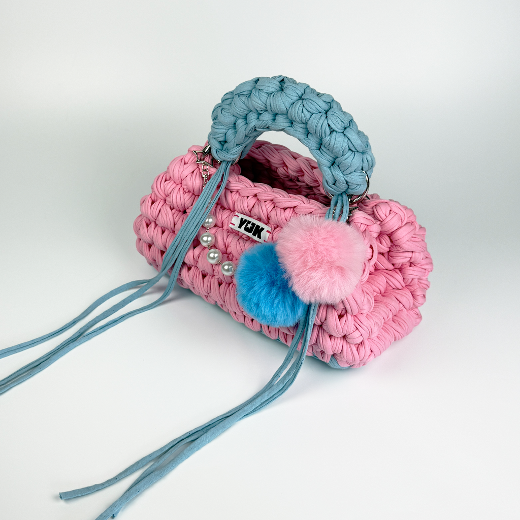 Handmade crochet handbag in pink and blue with a bag charm by Studio YUK