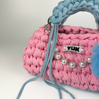 Handmade crochet handbag in pink and blue with a bag charm by Studio YUK