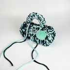 Handmade crochet handbag in blue with a bag charm by Studio YUK