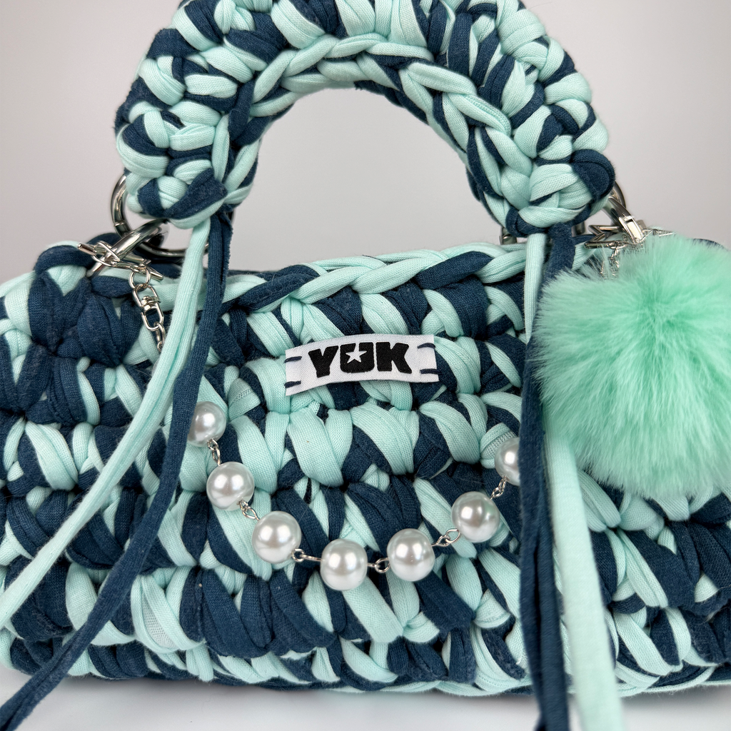 Handmade crochet handbag in blue with a bag charm by Studio YUK