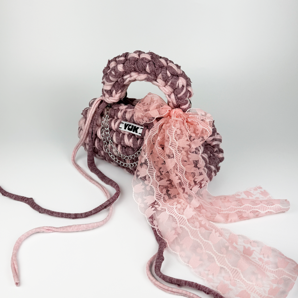 Handmade crochet handbag in pink with lace detail and a bag charm by Studio YUK
