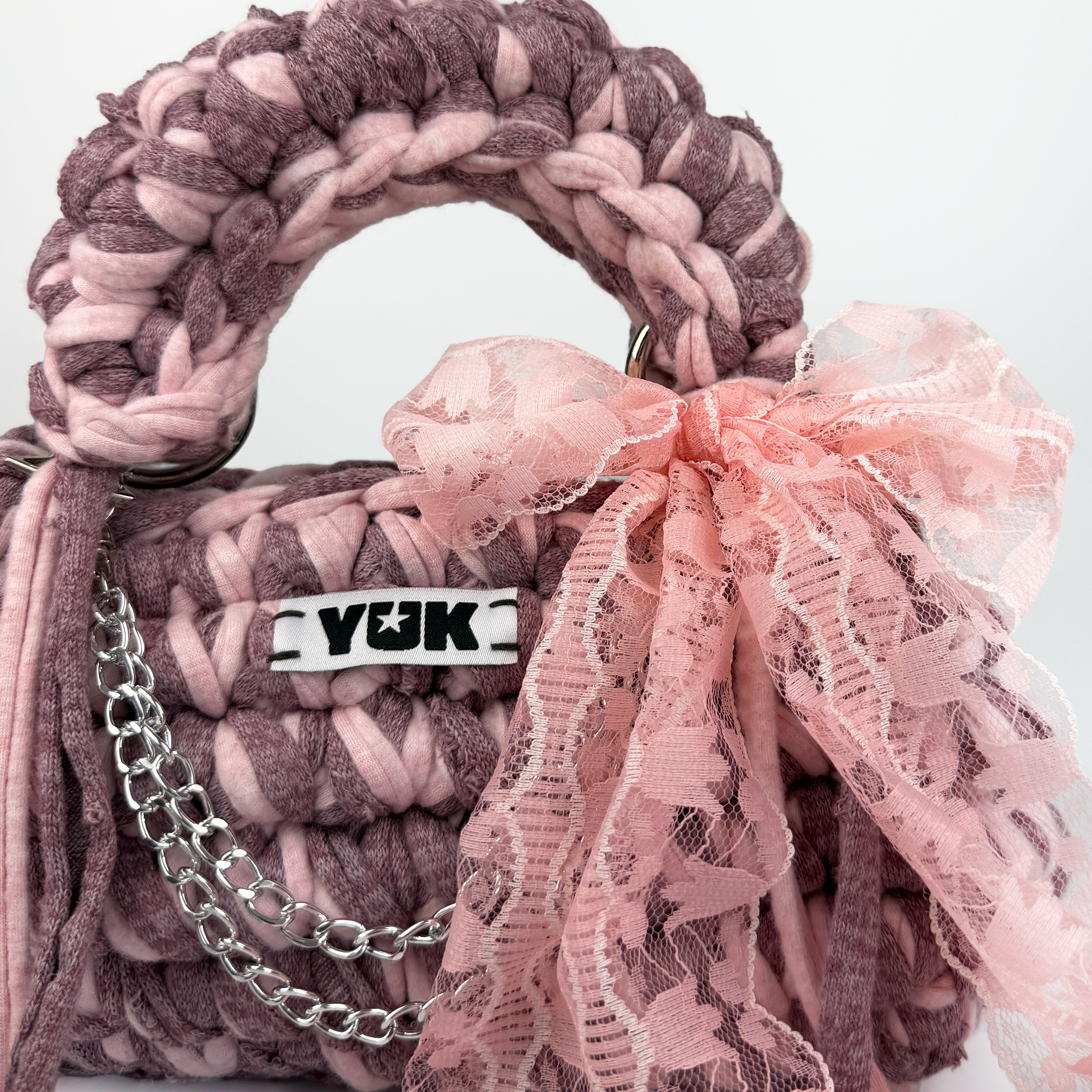 Handmade crochet handbag in pink with lace detail and a bag charm by Studio YUK