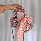 Handmade crochet handbag in pink with lace detail and a bag charm by Studio YUK