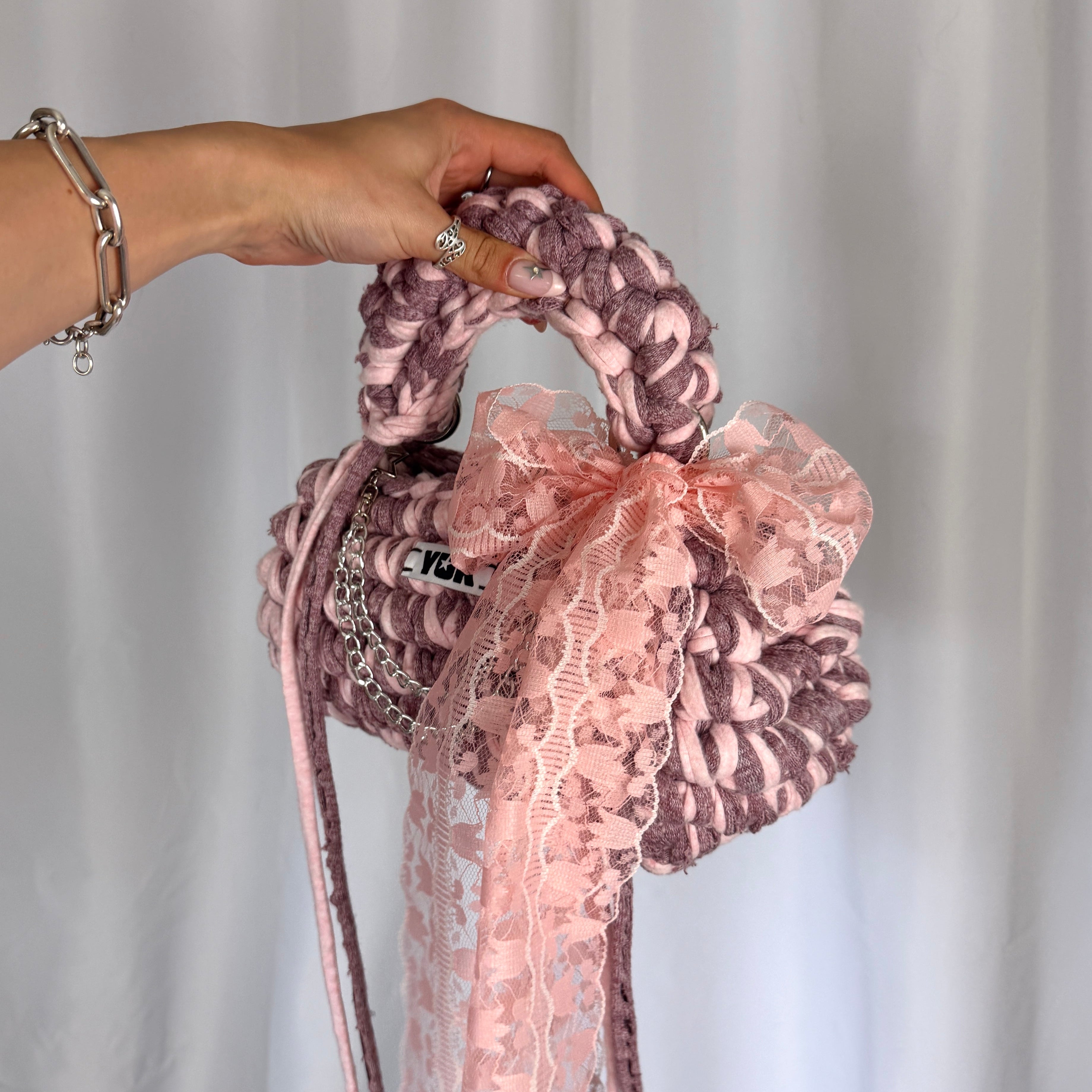Handmade crochet handbag in pink with lace detail and a bag charm by Studio YUK
