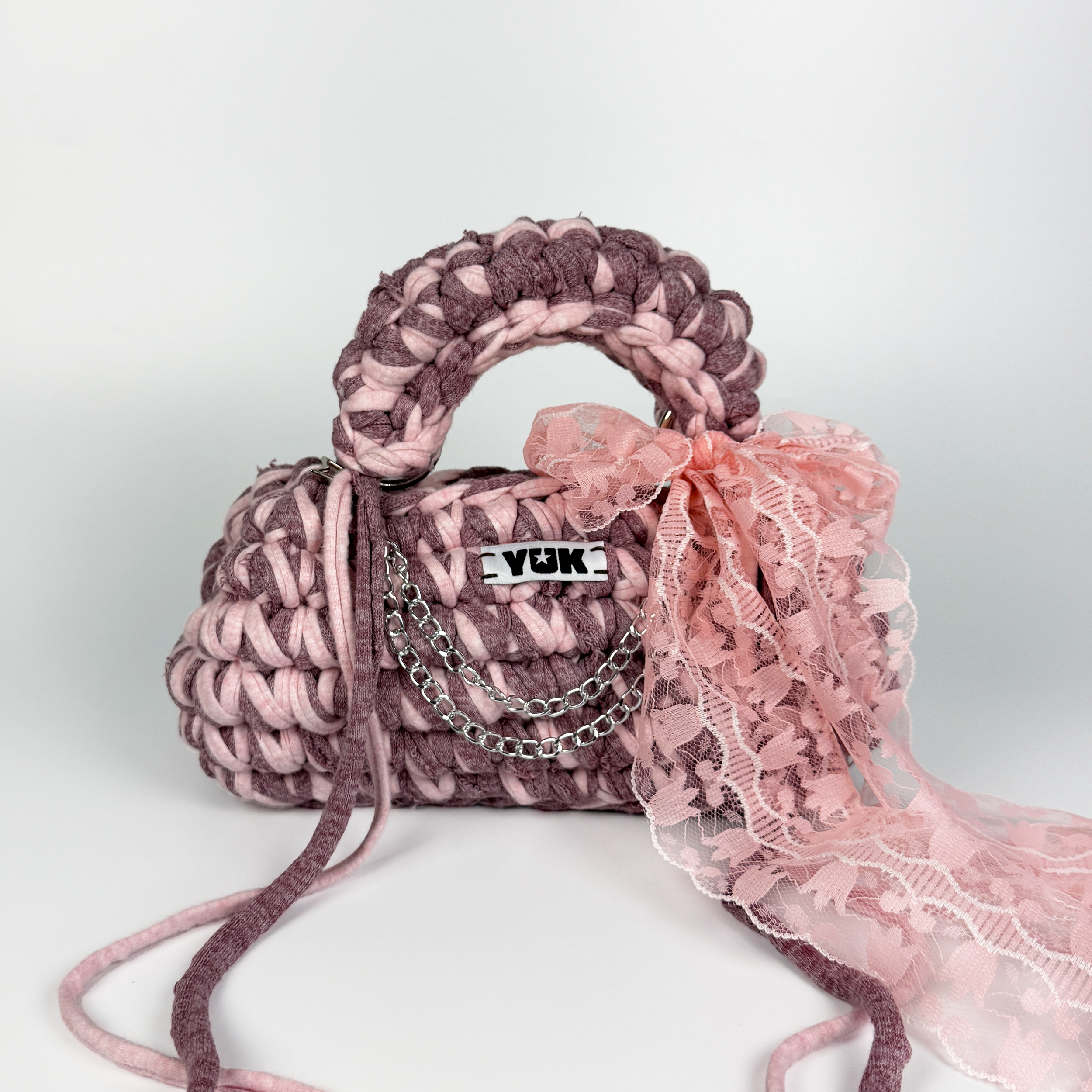 Handmade crochet handbag in pink with lace detail and a bag charm by Studio YUK