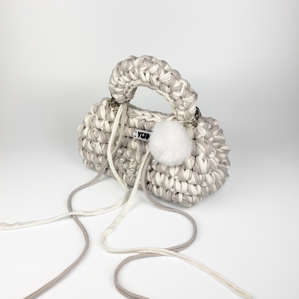 Handmade crochet handbag in white and grey with a bag charm by Studio YUK