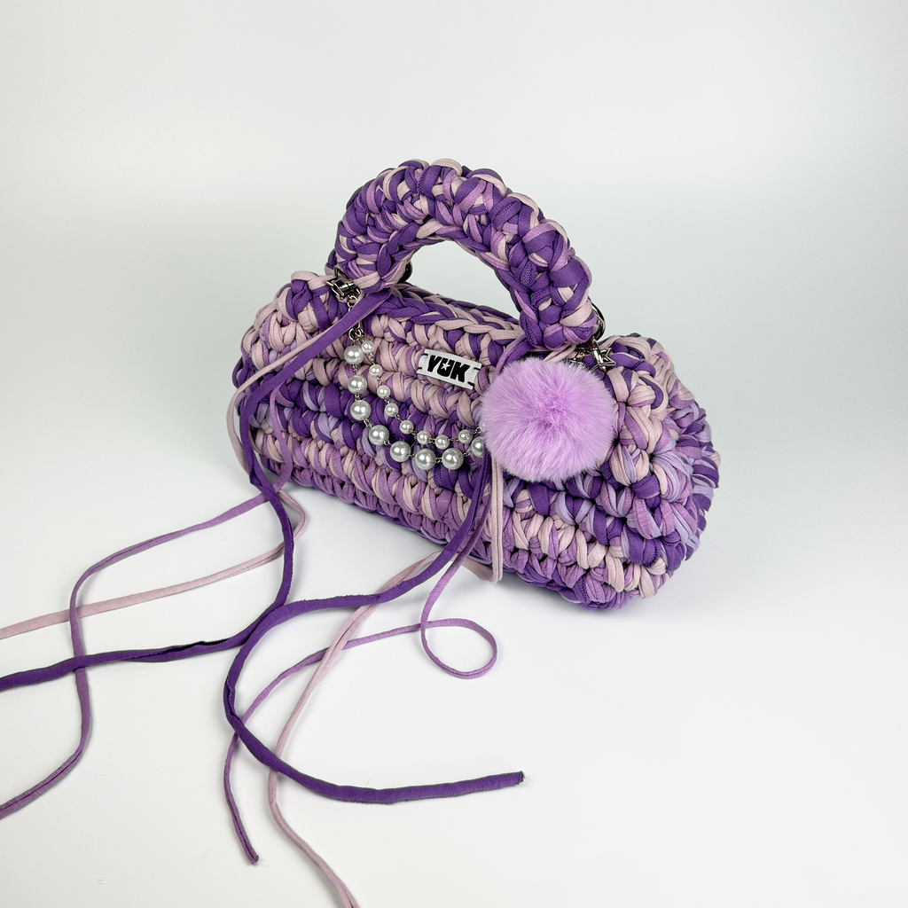 Handmade crochet handbag in purple and lilac with a bag charm by Studio YUK