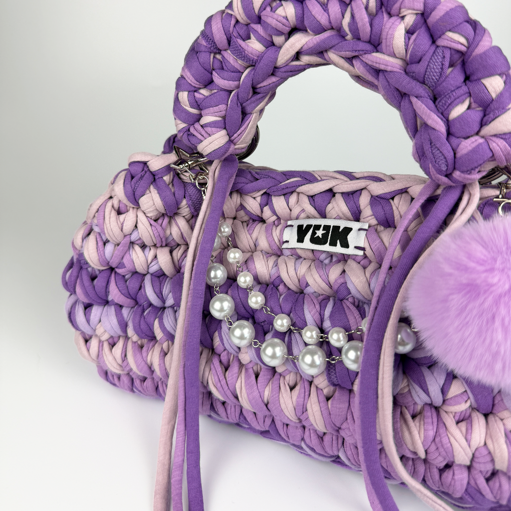Handmade crochet handbag in purple and lilac with a bag charm by Studio YUK