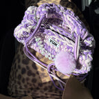 Lifestyle image featuring the purple and lilac Studio YUK crochet handbag