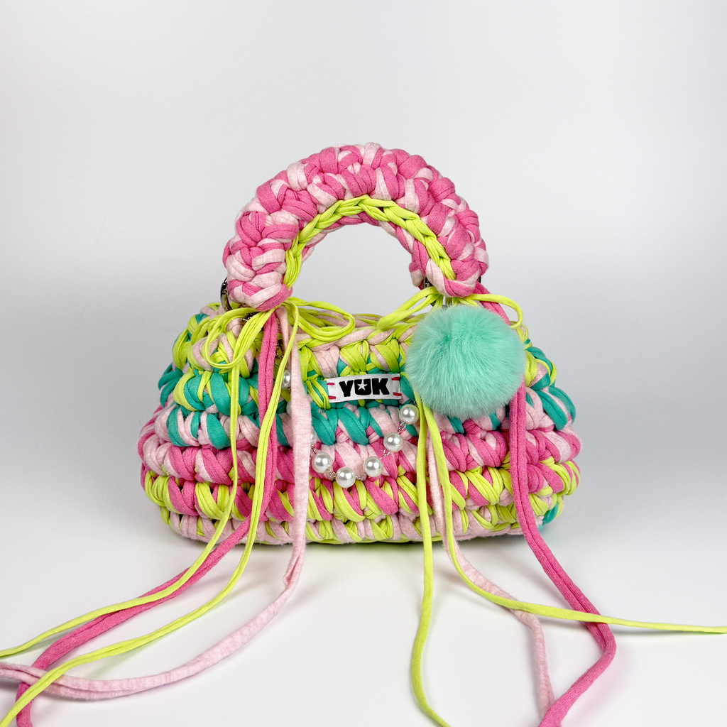 Handmade crochet handbag in rainbow colors with a bag charm by Studio YUK