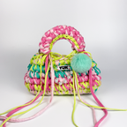 Handmade crochet handbag in rainbow colors with a bag charm by Studio YUK