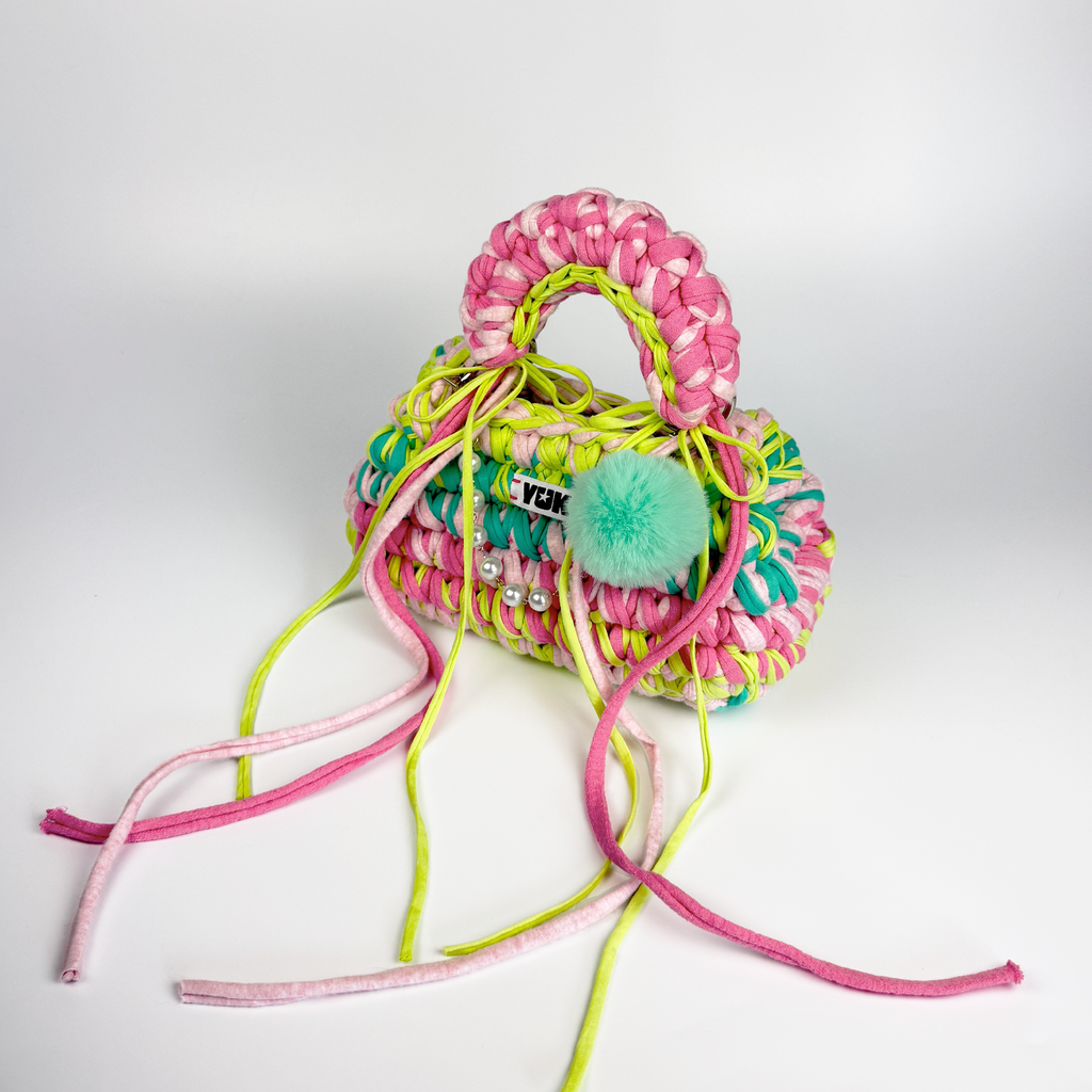 Handmade crochet handbag in rainbow colors with a bag charm by Studio YUK