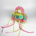 Handmade crochet handbag in rainbow colors with a bag charm by Studio YUK