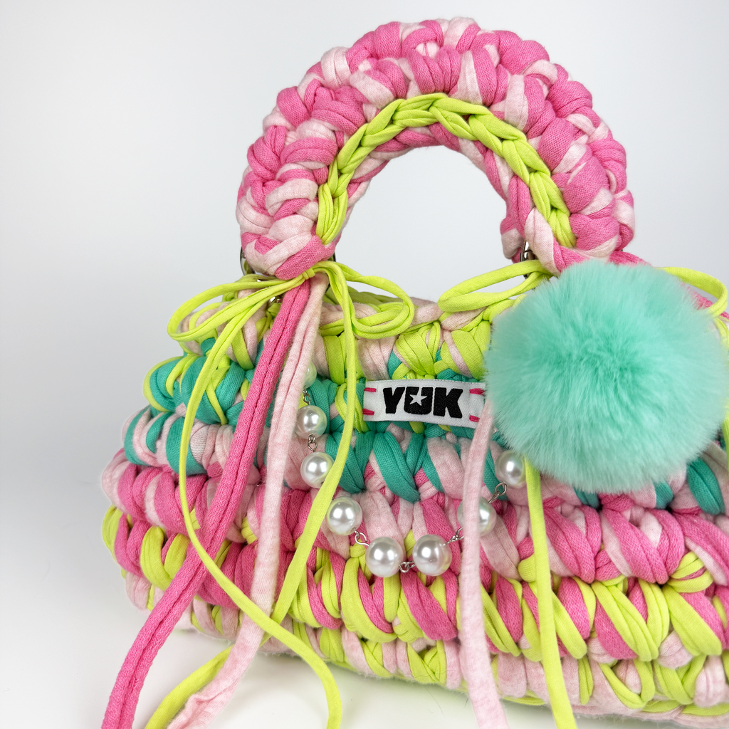 Handmade crochet handbag in rainbow colors with a bag charm by Studio YUK