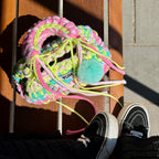 Lifestyle image featuring the rainbow colored Studio YUK crochet handbag