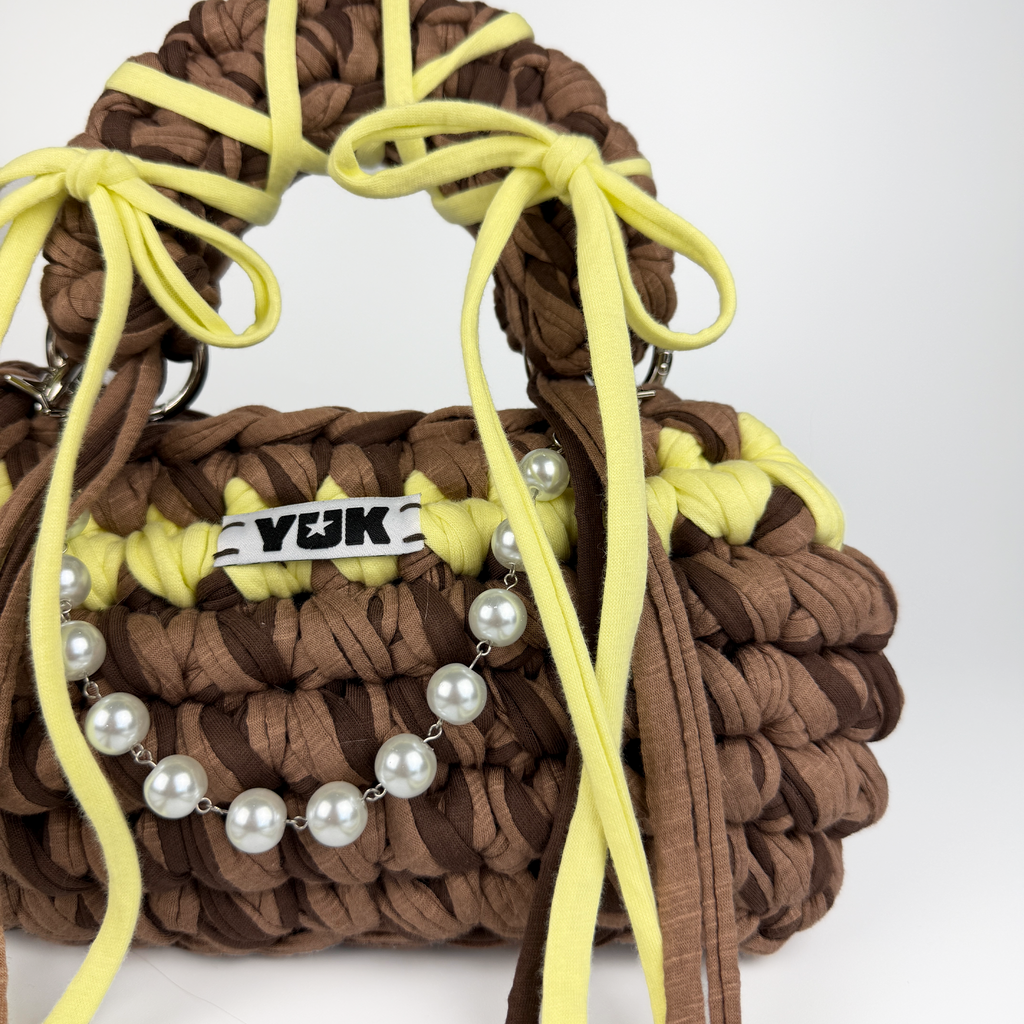 Handmade crochet handbag in brown and yellow with a bag charm by Studio YUK