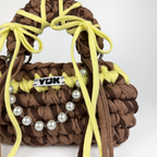 Handmade crochet handbag in brown and yellow with a bag charm by Studio YUK