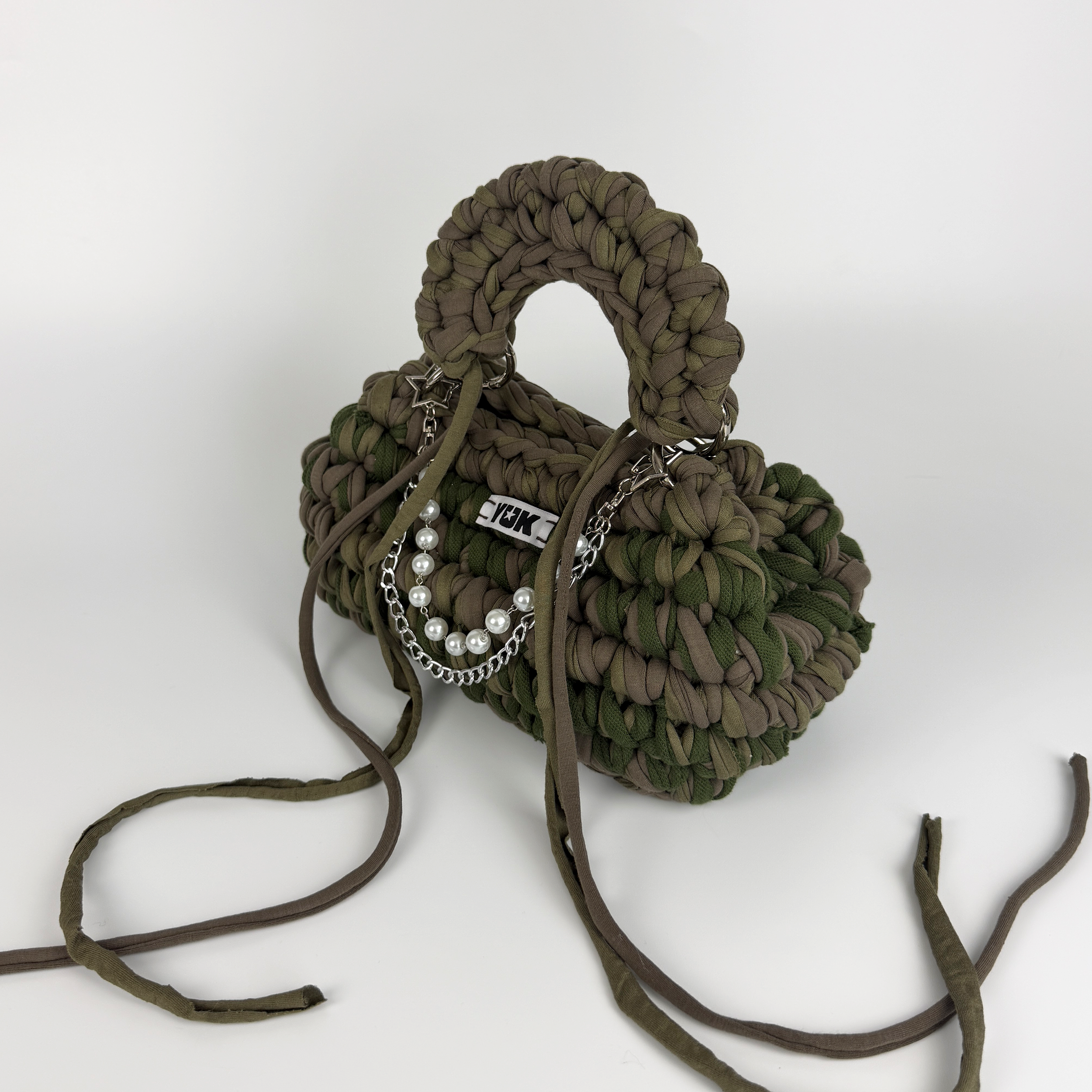 Handmade crochet handbag in a green and taupe mix with a bag charm by Studio YUK