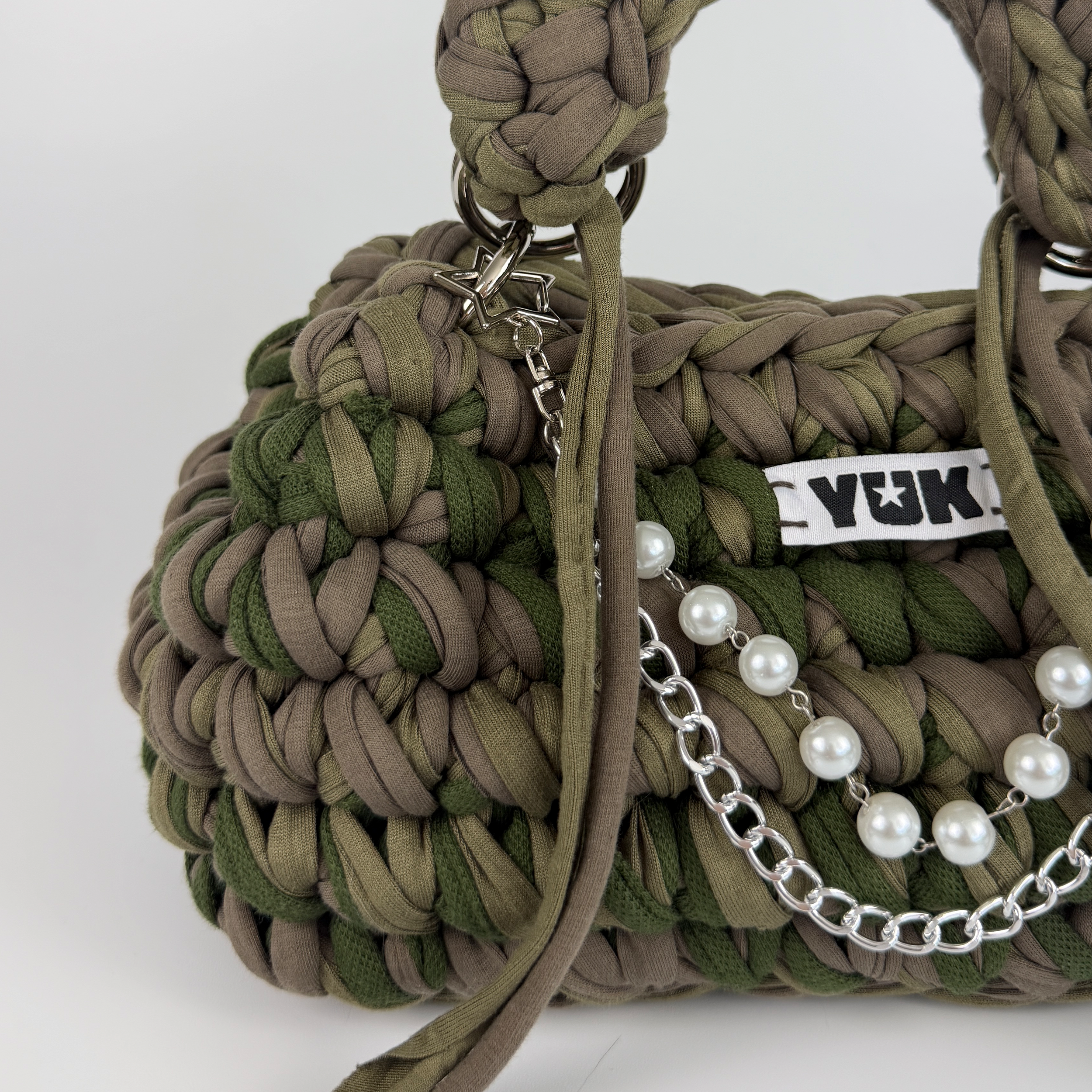 Handmade crochet handbag in a green and taupe mix with a bag charm by Studio YUK
