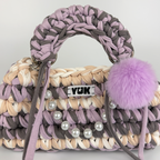 Handmade crochet handbag in lilac, purple, grey, white and beige with a bag charm by Studio YUK
