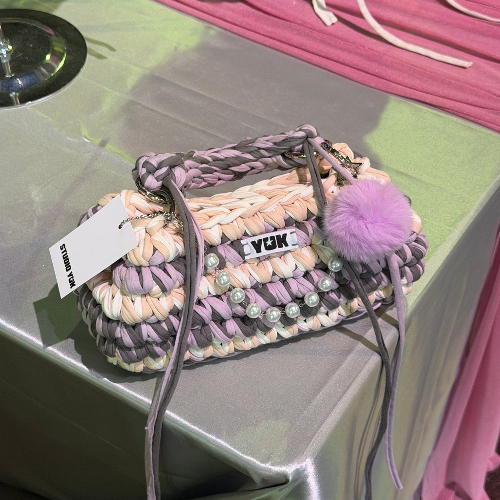 Handmade crochet handbag in lilac, purple, grey, white and beige with a bag charm by Studio YUK