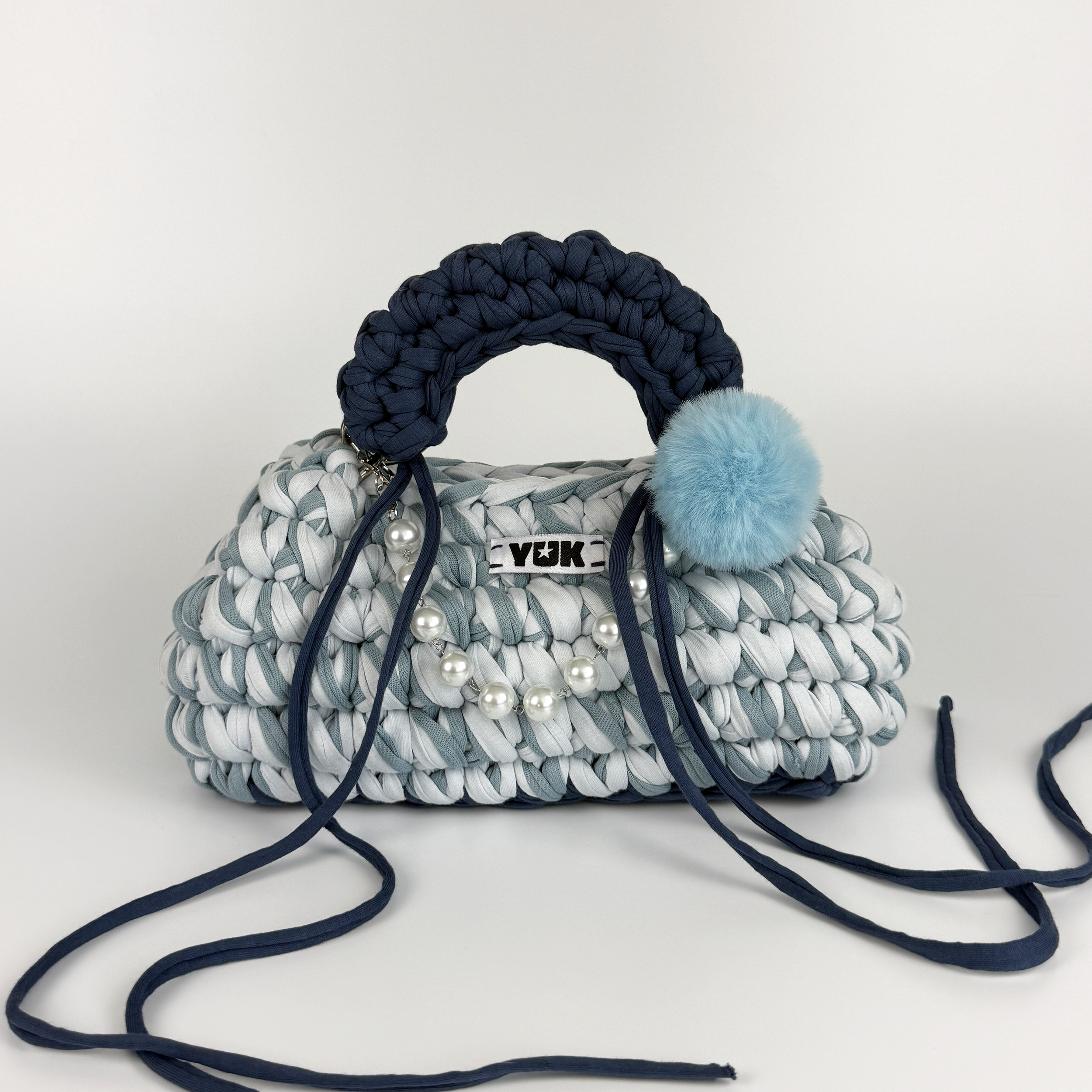 Handmade crochet handbag in a blue mix and a bag charm by Studio YUK
