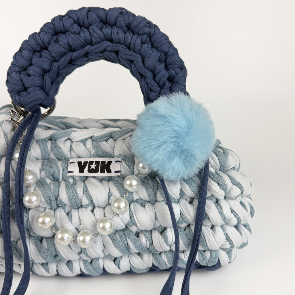 Handmade crochet handbag in a blue mix and a bag charm by Studio YUK