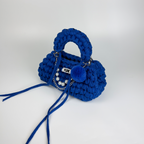 Handmade crochet handbag in blue with a bag charm by Studio YUK