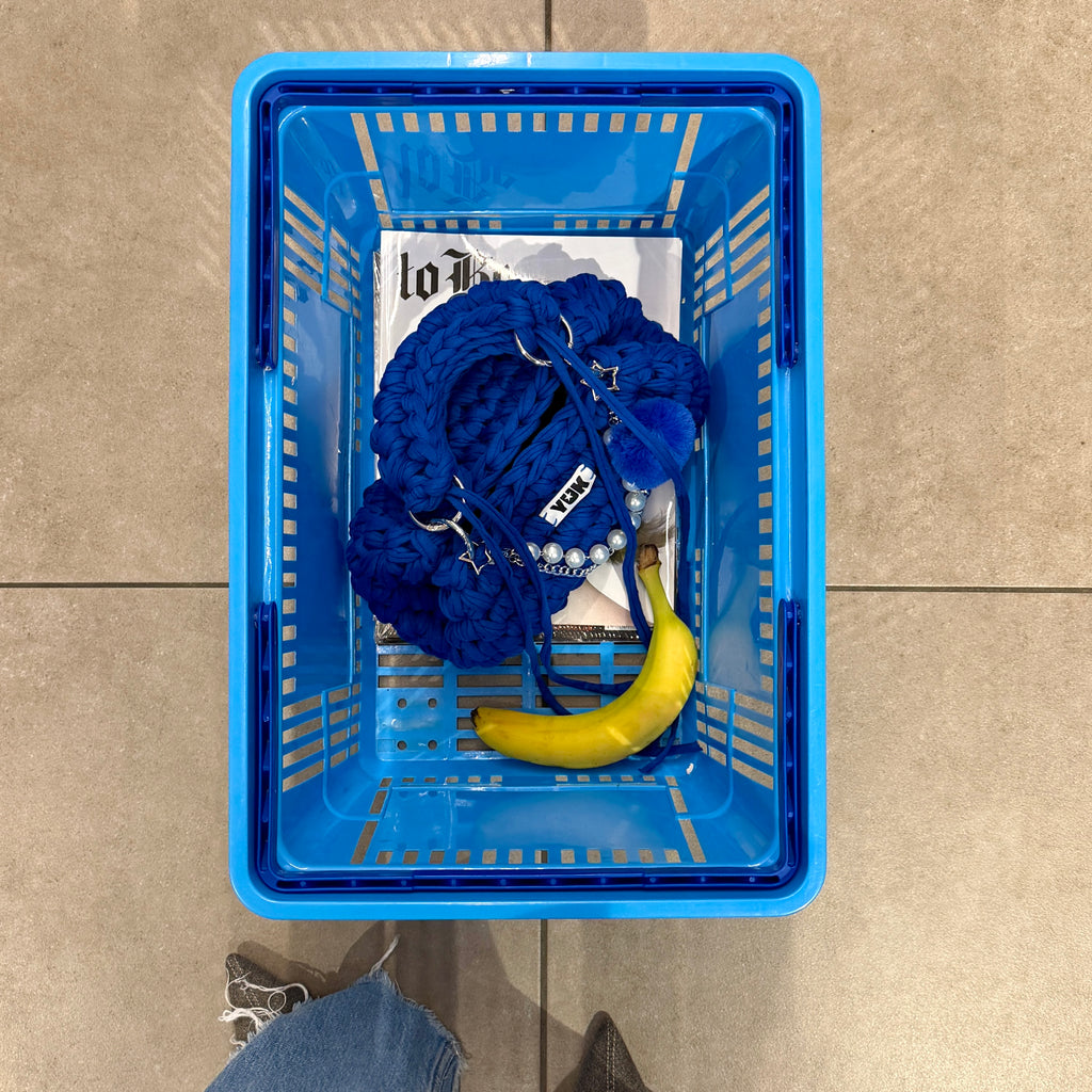 Lifestyle image featuring the blue Studio YUK crochet handbag