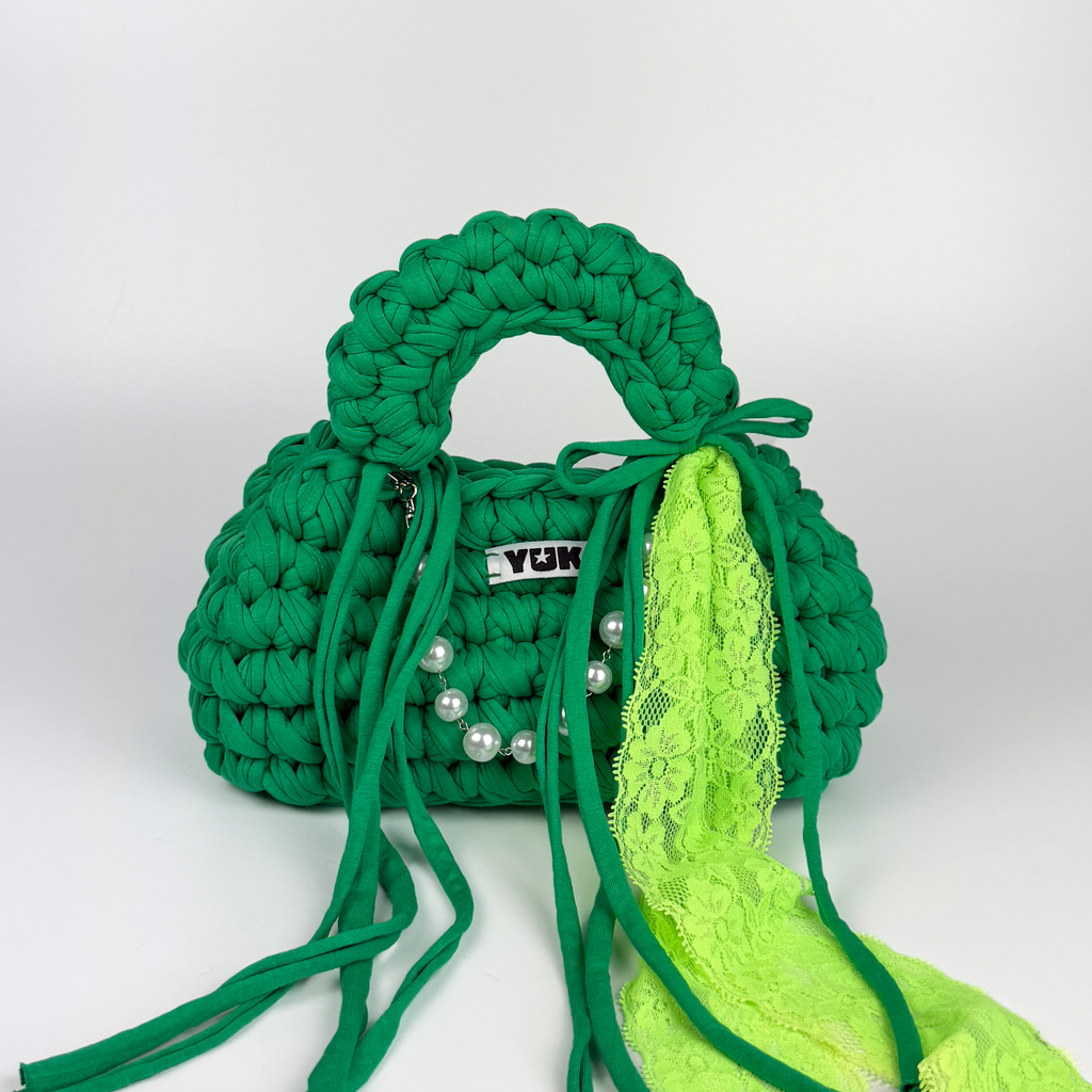 Handmade crochet handbag in green with lace detail and a bag charm by Studio YUK