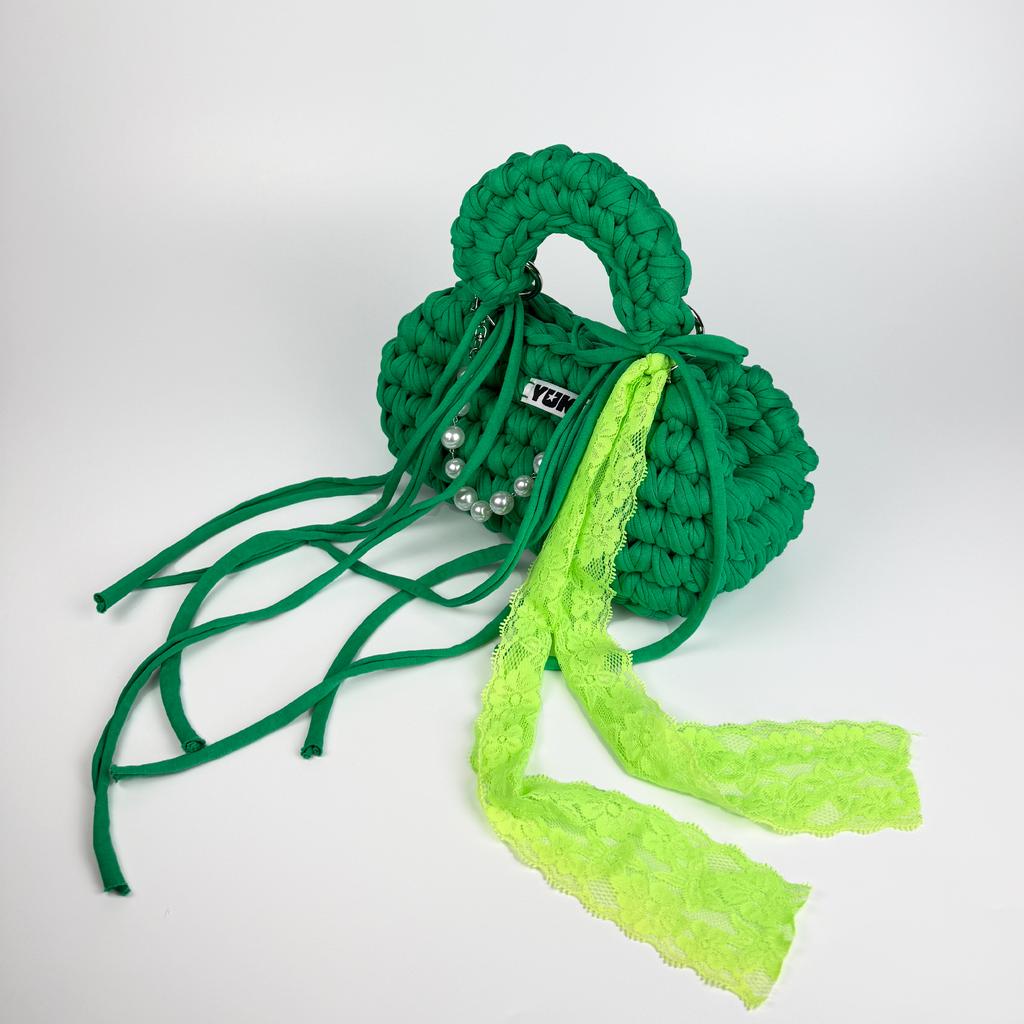 Handmade crochet handbag in green with lace detail and a bag charm by Studio YUK