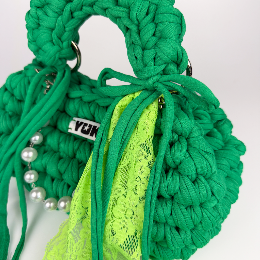 Handmade crochet handbag in green with lace detail and a bag charm by Studio YUK