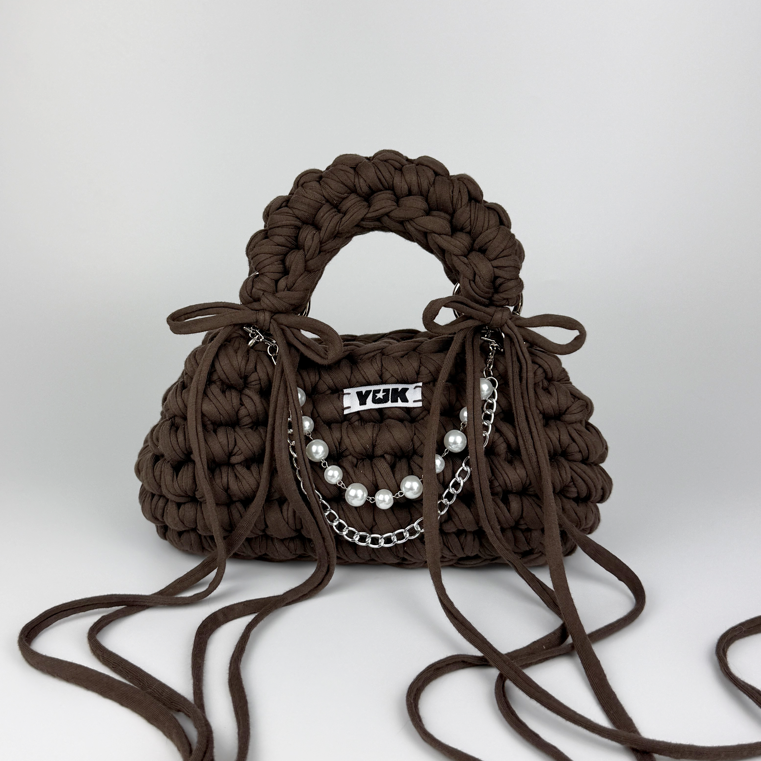 Handmade crochet handbag in brown with a bag charm by Studio YUK