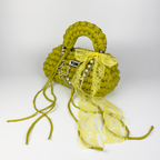Handmade crochet handbag in green and yellow with lace detail and a bag charm by Studio YUK