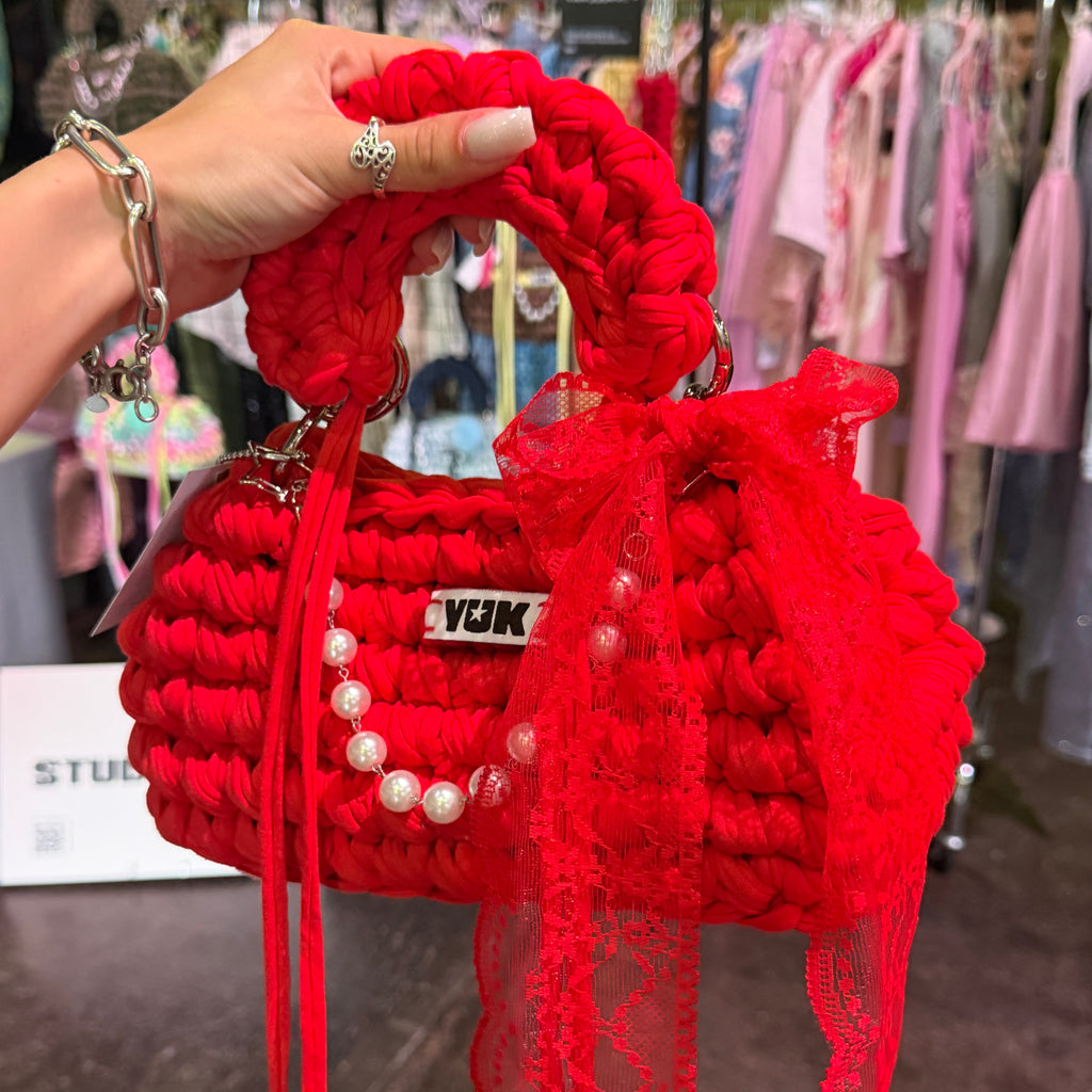 Handmade crochet handbag in red with lace detail and a bag charm by Studio YUK