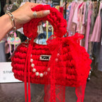 Handmade crochet handbag in red with lace detail and a bag charm by Studio YUK