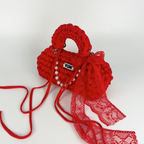 Handmade crochet handbag in red with lace detail and a bag charm by Studio YUK