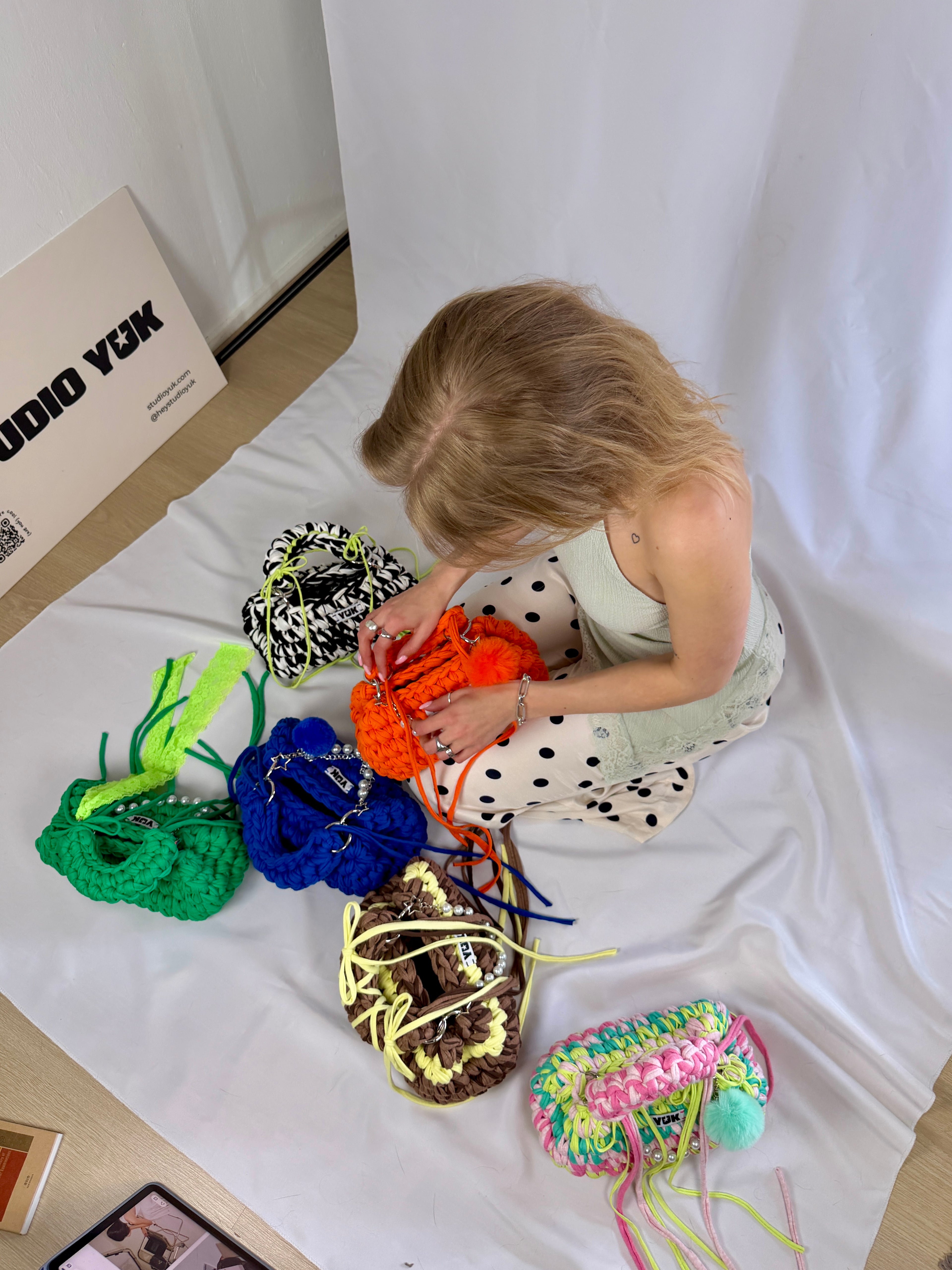 Behind the scenes of Studio YUK founder working on handmade crochet handbags